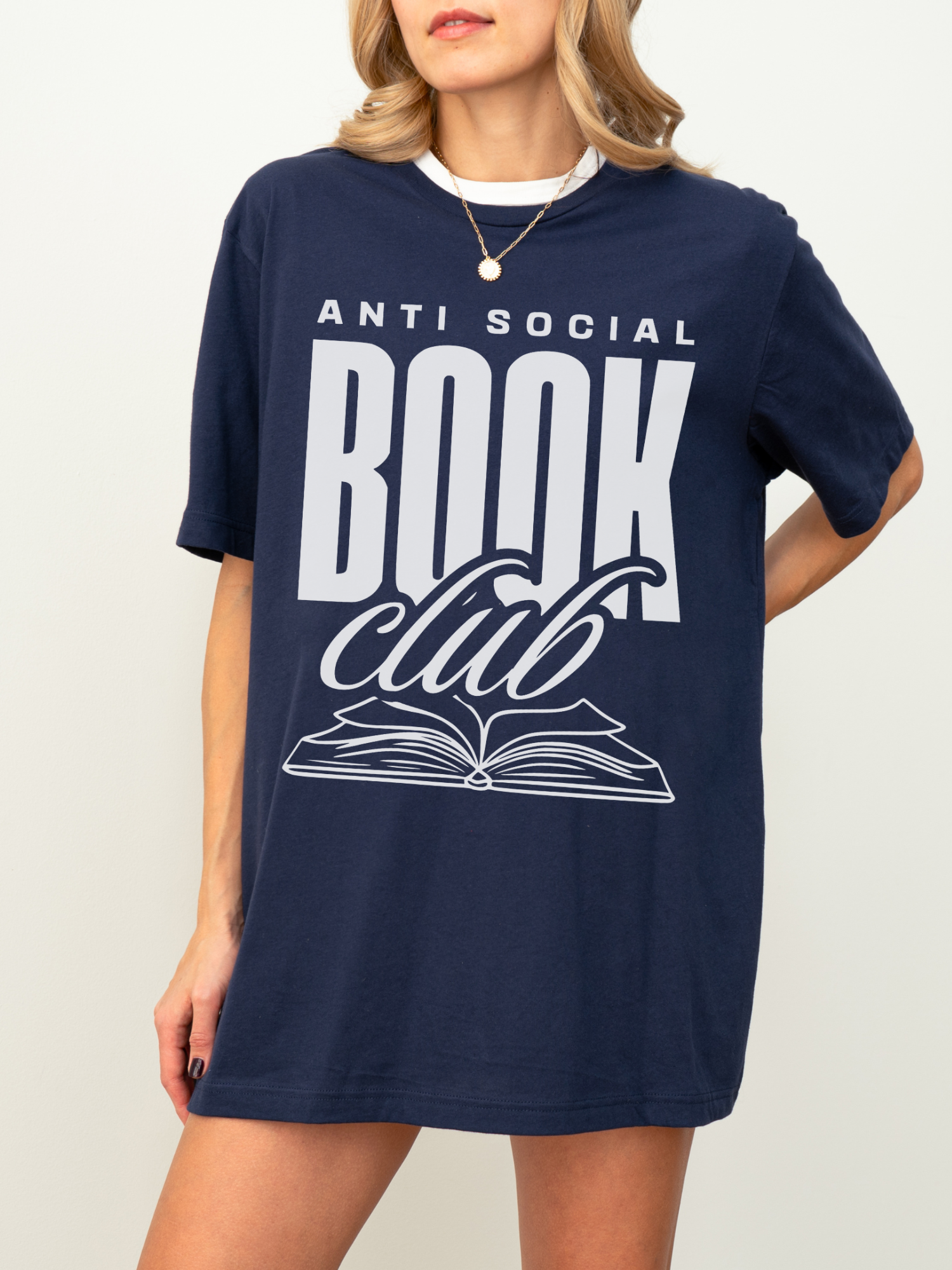 woman wearing a navy blue t-shirt with large anti social book club text and open book graphic in soft ink