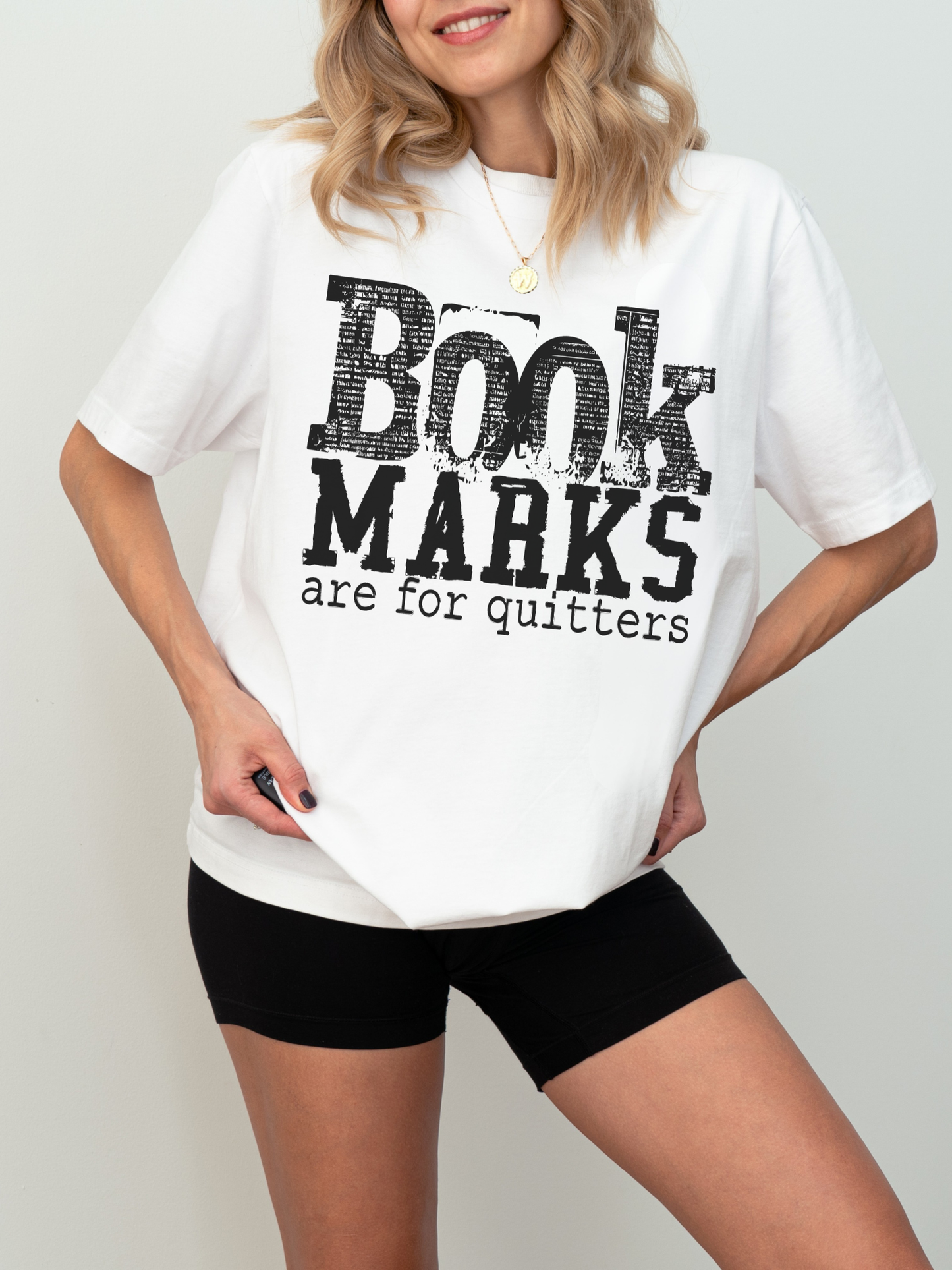 white comfort colors book marks are for quitters shirt with bold black distressed typography for readers and librarians