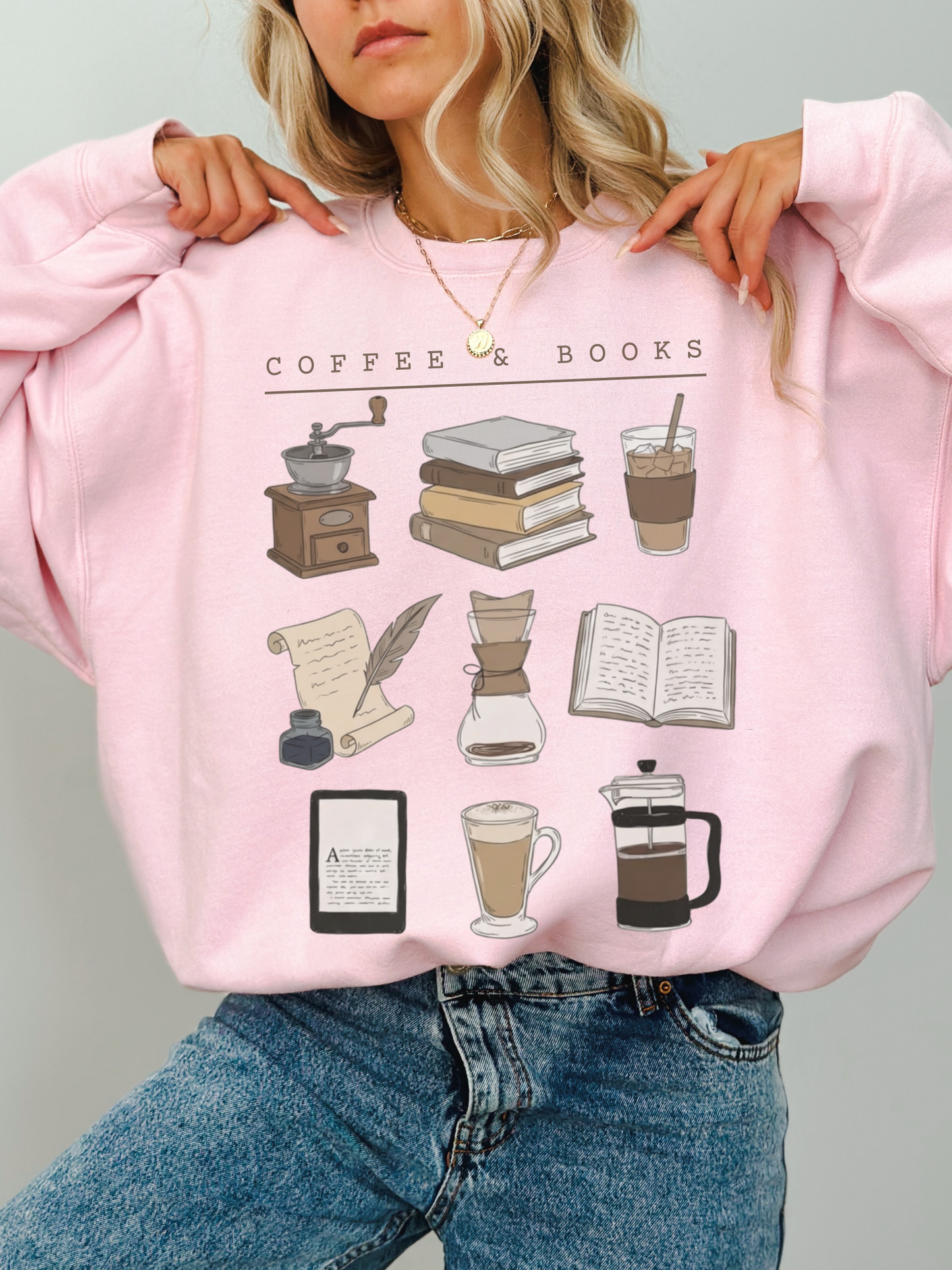 pink coffee and books crewneck sweatshirt worn by blonde woman with layered gold necklaces
