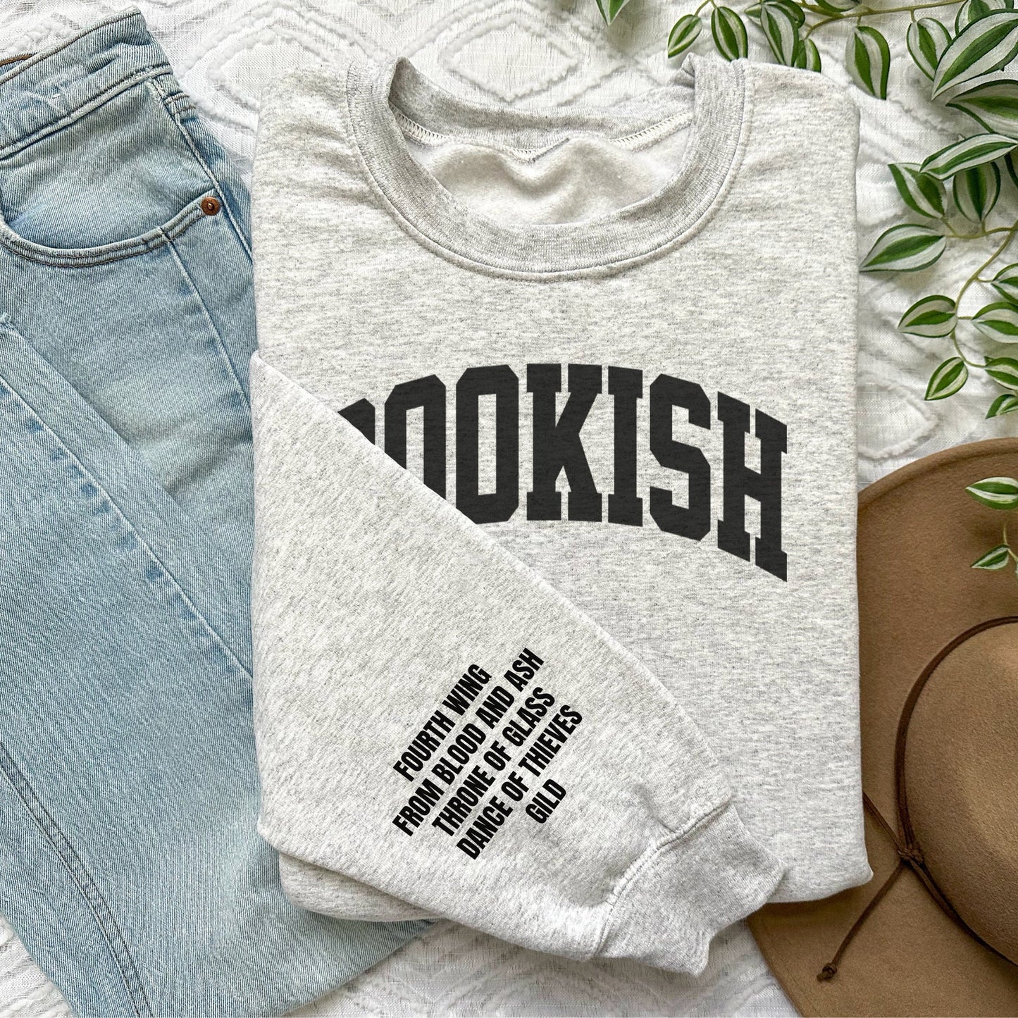folded ash grey sweatshirt with black BOOKISH text and popular book titles listed down the sleeve