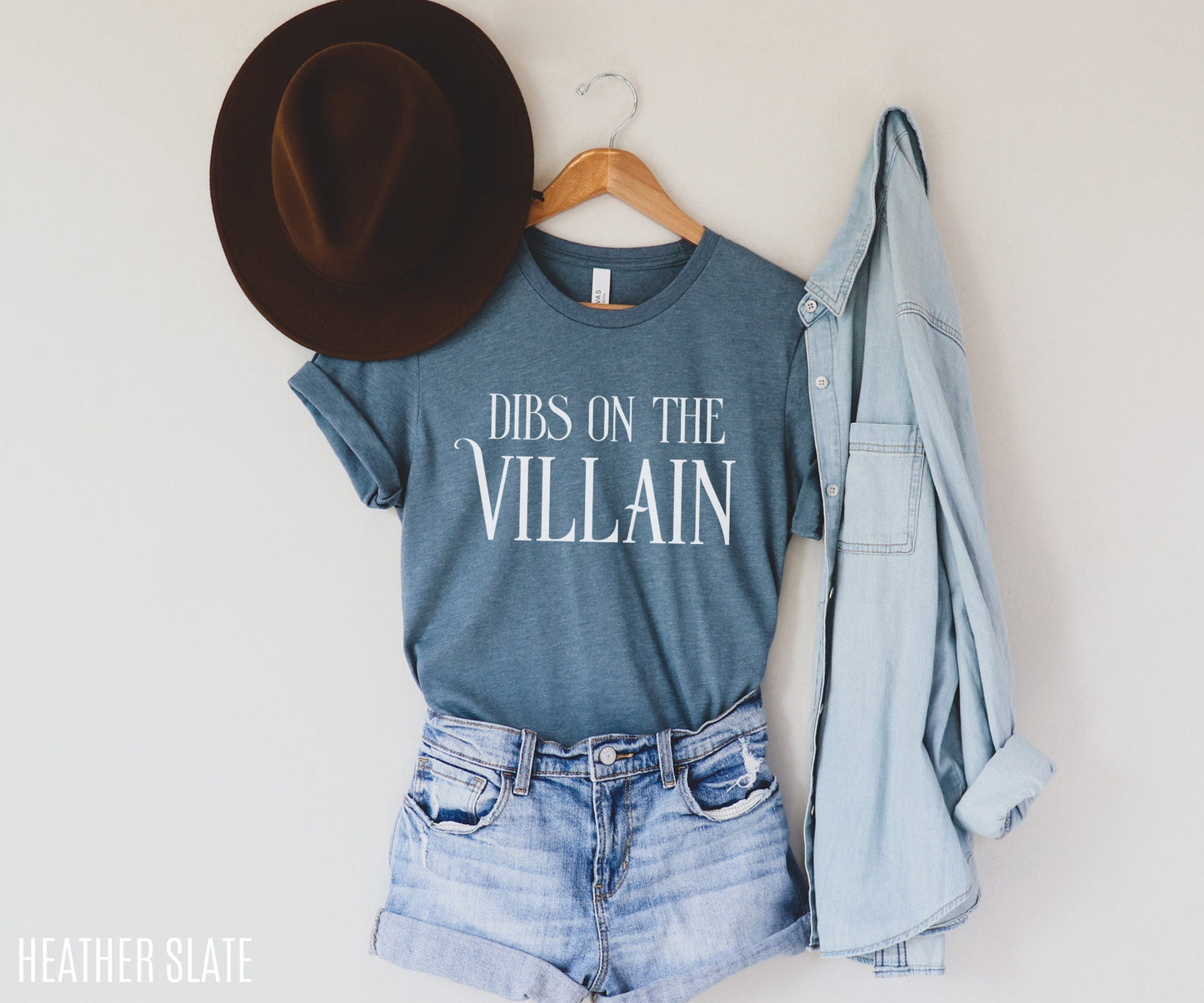 heather slate blue Dibs on the Villain t-shirt styled with jean shorts, hat, and denim shirt