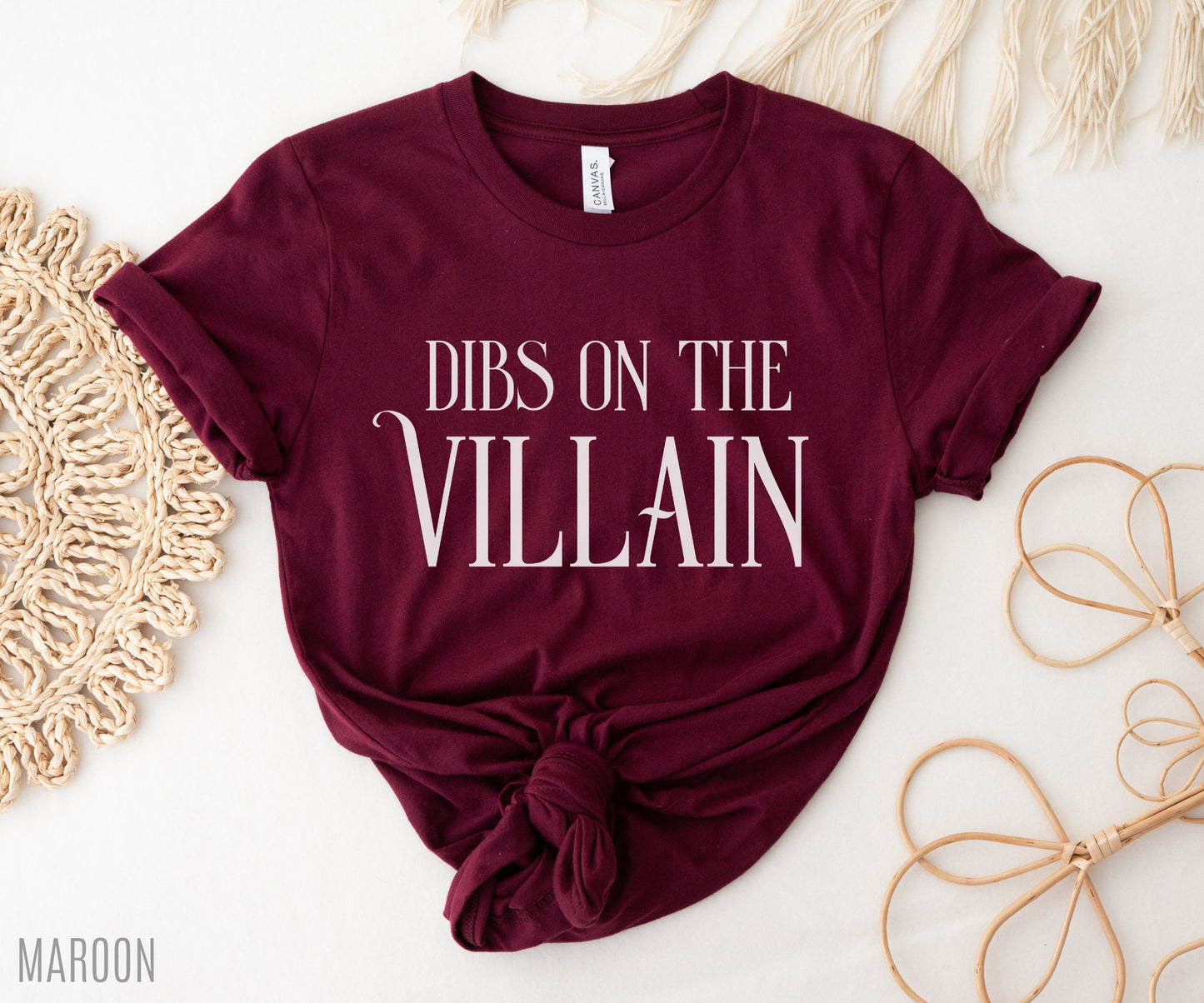 flat lay of maroon Dibs on the Villain t-shirt with knotted hem and soft bookish styling