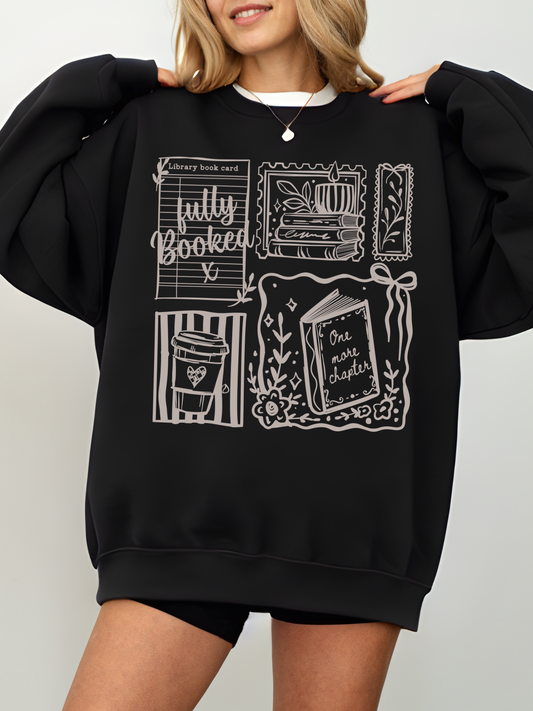 woman wearing black fully booked book lover sweatshirt with vintage reading illustrations cozy oversized fit aesthetic