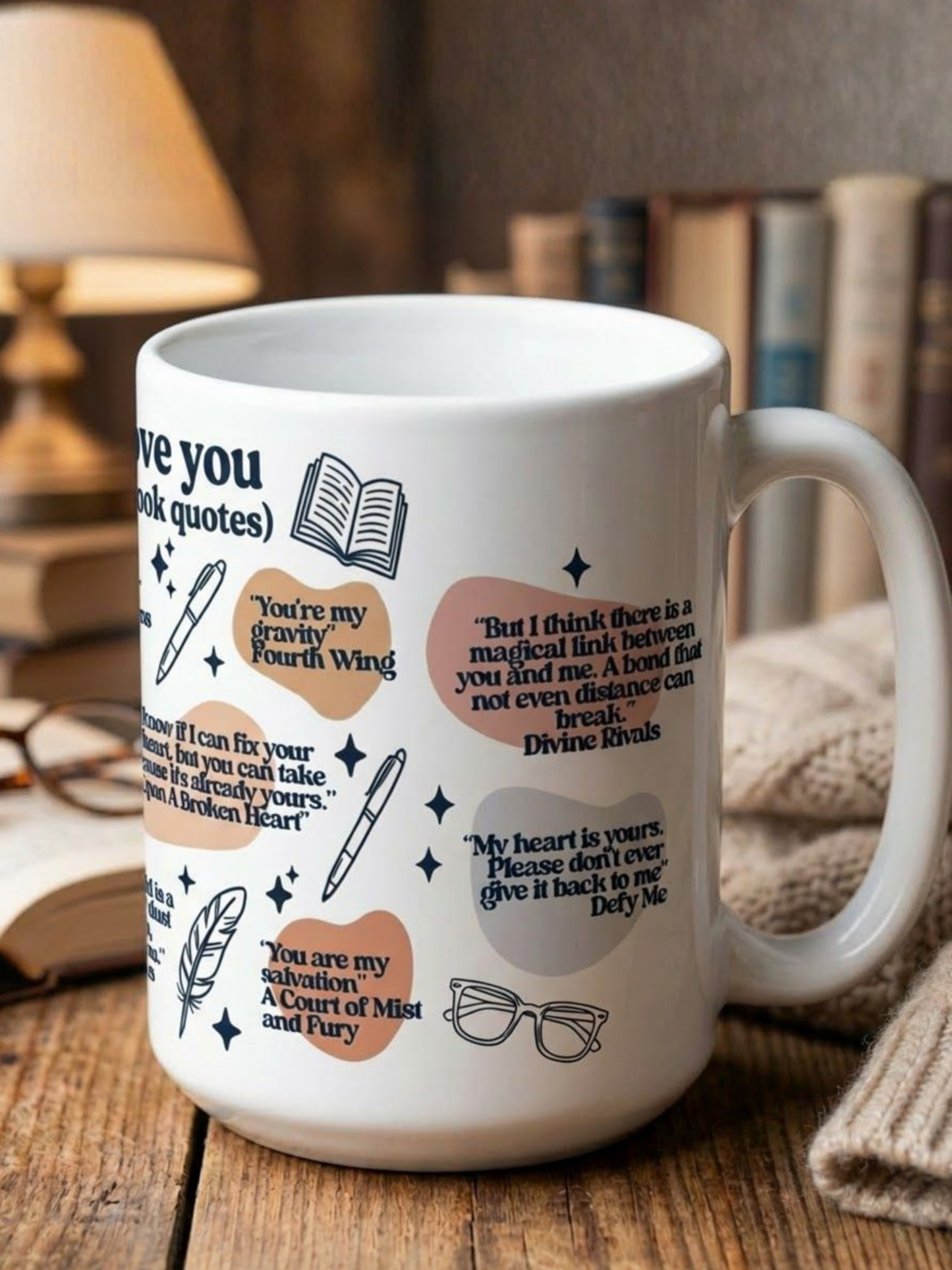 White I Love You in Book Quotes coffee mug styled on wooden table with stacked books and warm lamp light featuring romance novel quotes and illustrated bookish icons