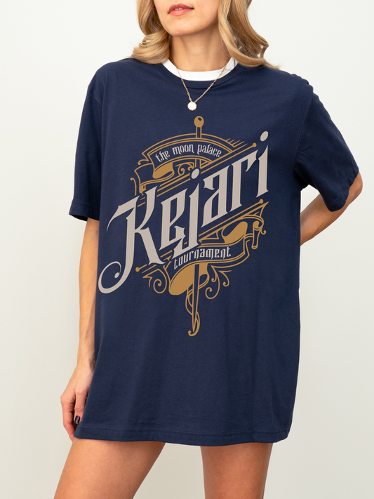 Navy blue shirt with The Kejari Tournament graphic in vintage fantasy lettering, styled by woman with necklace, officially licensed from Crowns of Nyaxia.