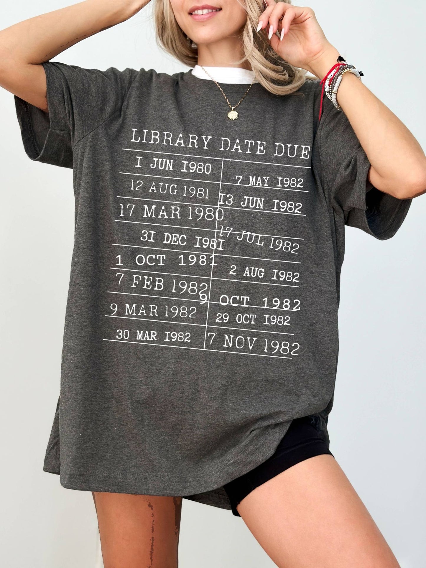 woman wearing a dark grey heather t-shirt with retro library due date graphic
