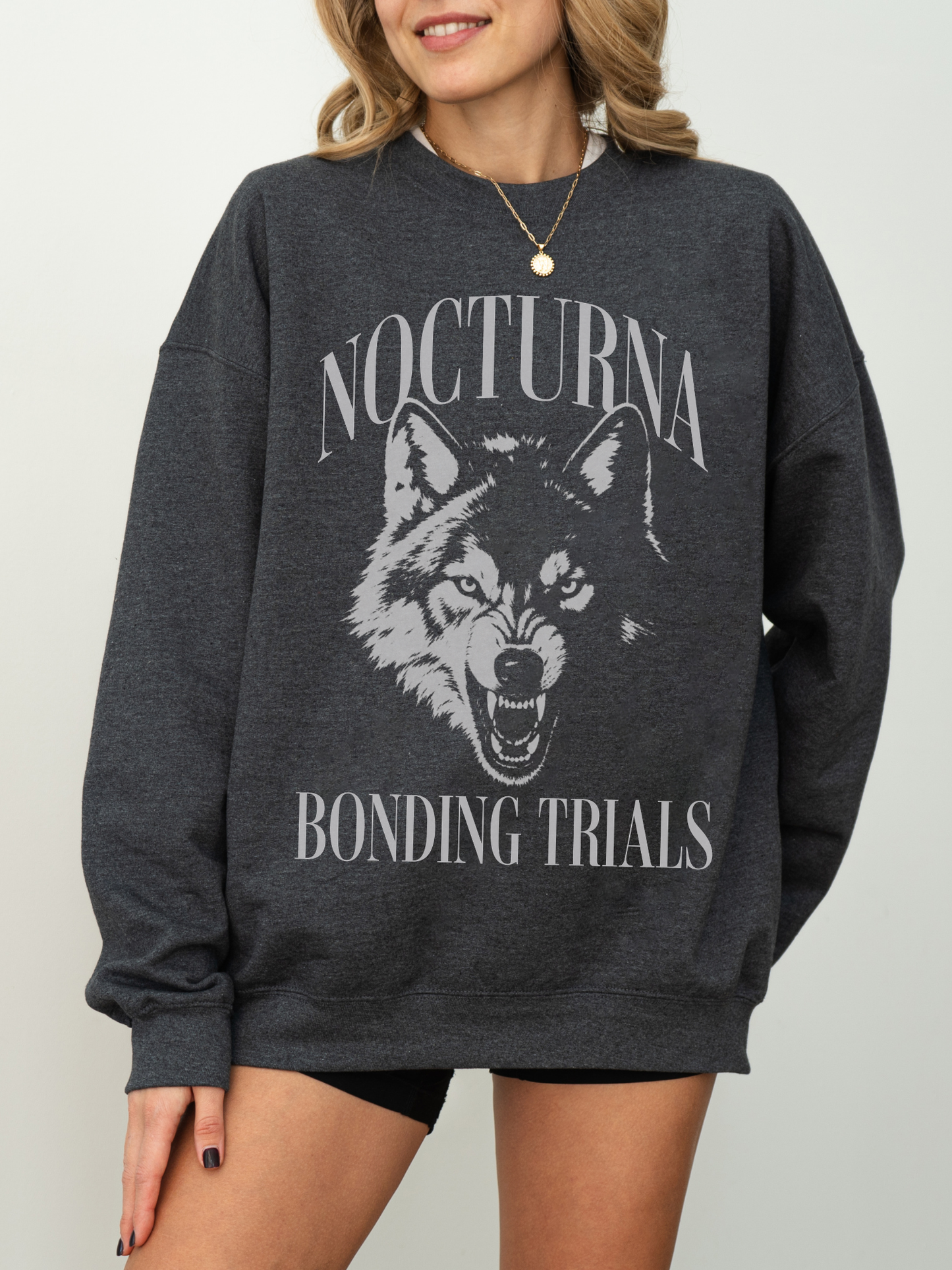 dark grey heather sweatshirt featuring Nocturna Bonding Trials wolf design for fantasy book lovers
