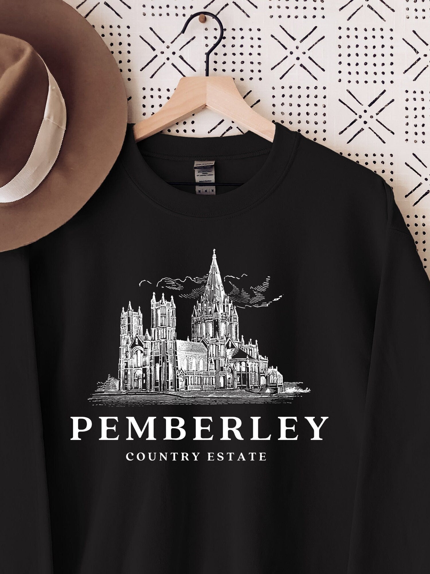 black sweatshirt on hanger with white line drawing of Pemberley and text reading country estate