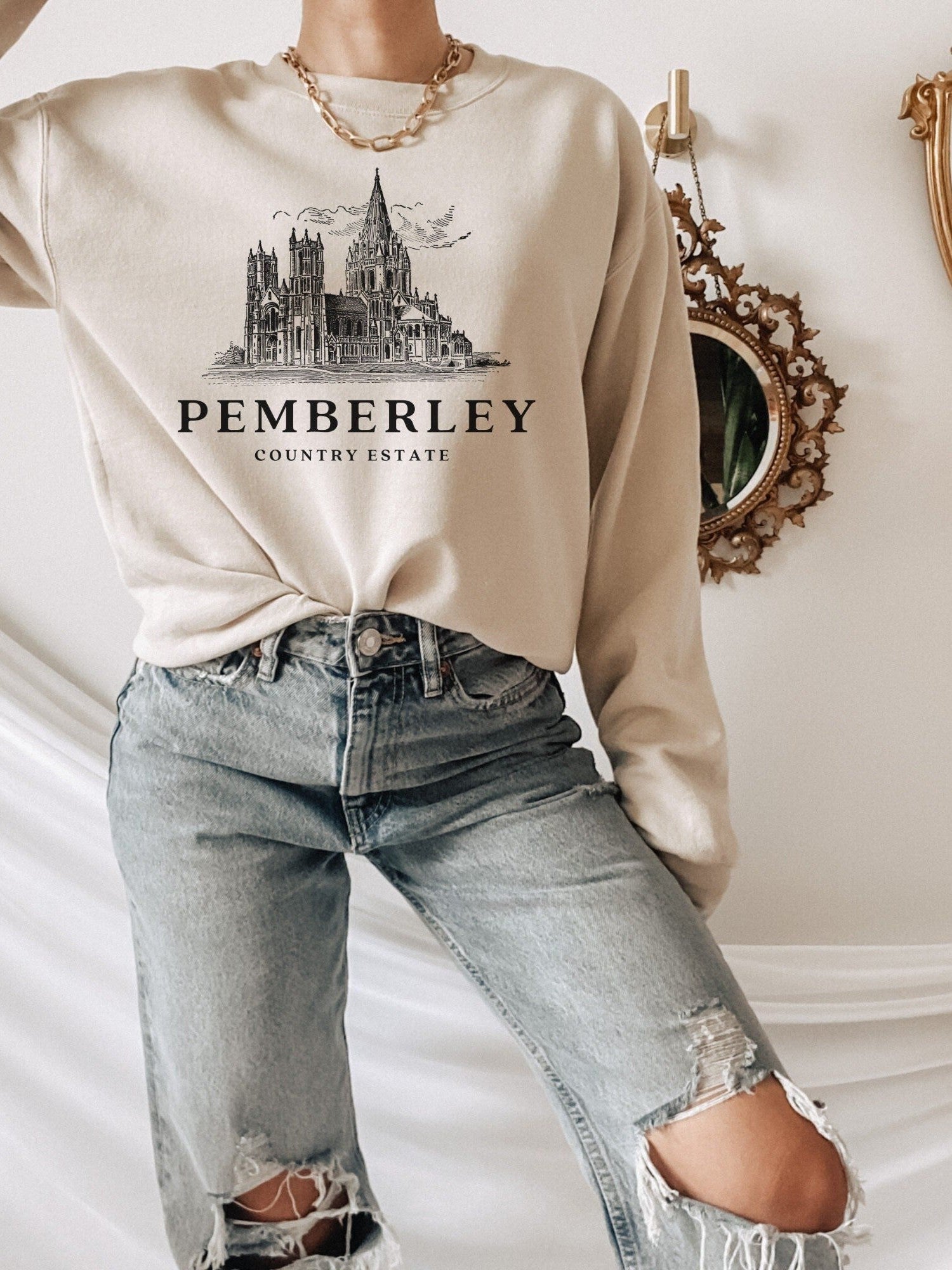 woman wearing sand sweatshirt with vintage sketch of Pemberley and country estate text