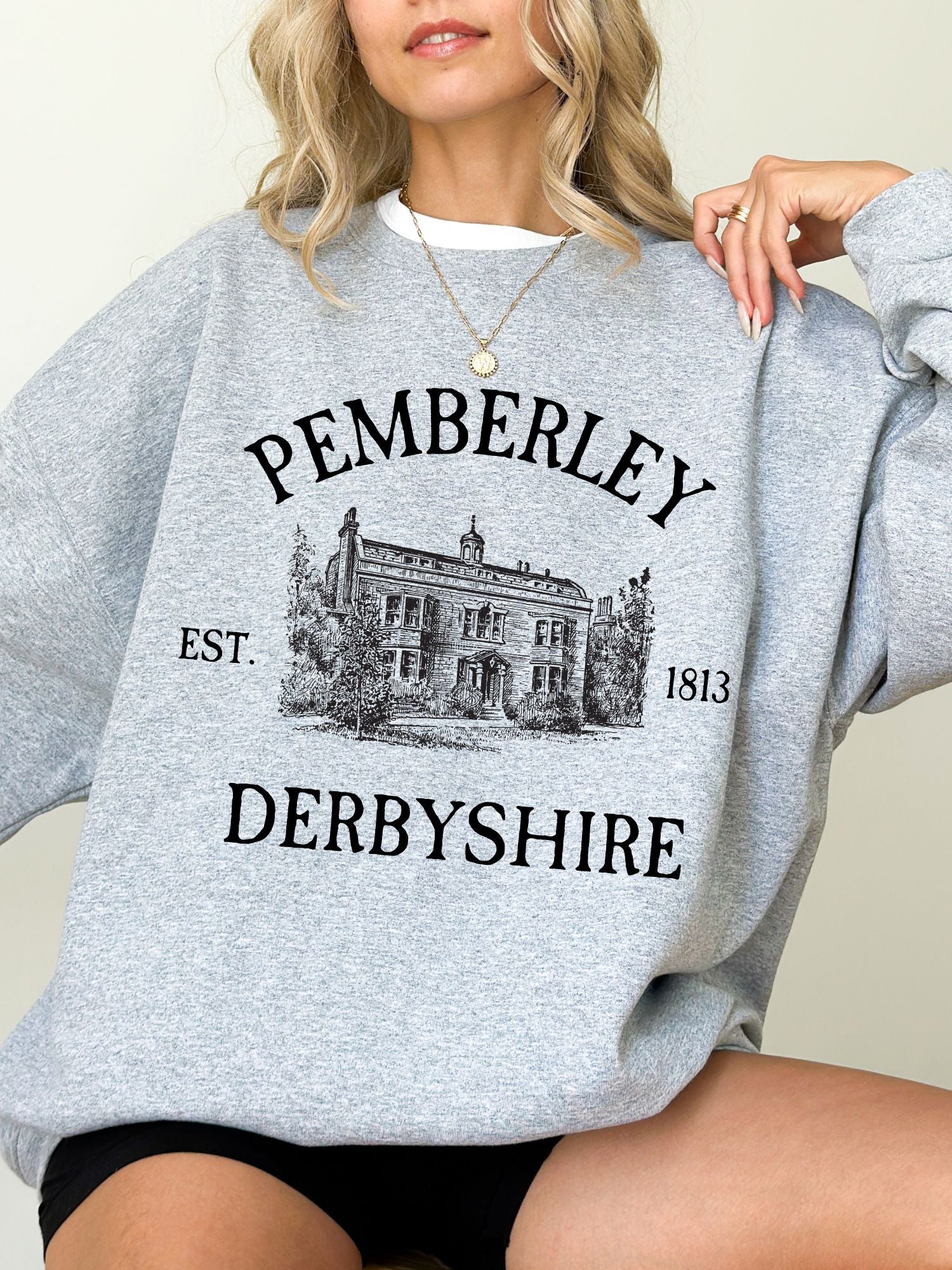 woman wearing sport grey sweatshirt with vintage Pemberley Derbyshire illustration and 1813 date