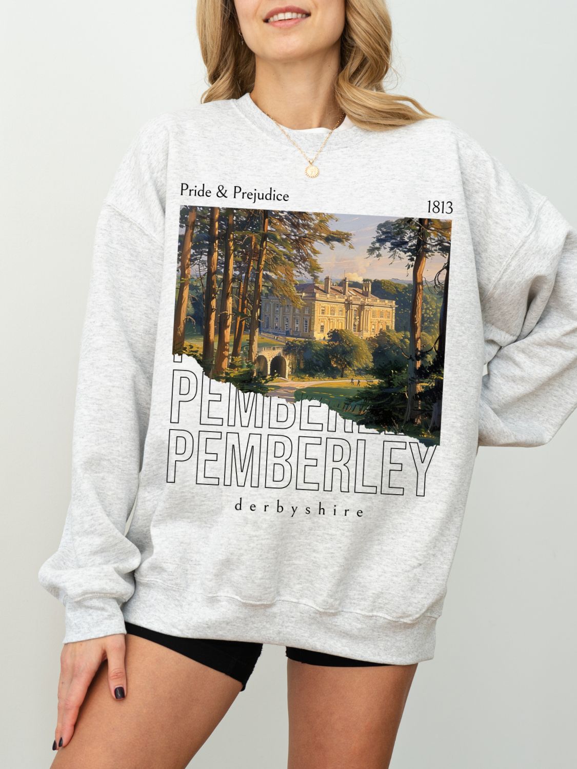 woman wearing ash grey sweatshirt with vintage Pemberley painting and Pride and Prejudice text