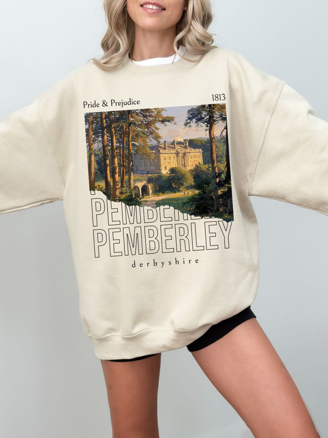 woman wearing sand Pemberley sweatshirt with vintage Pride and Prejudice inspired estate artwork