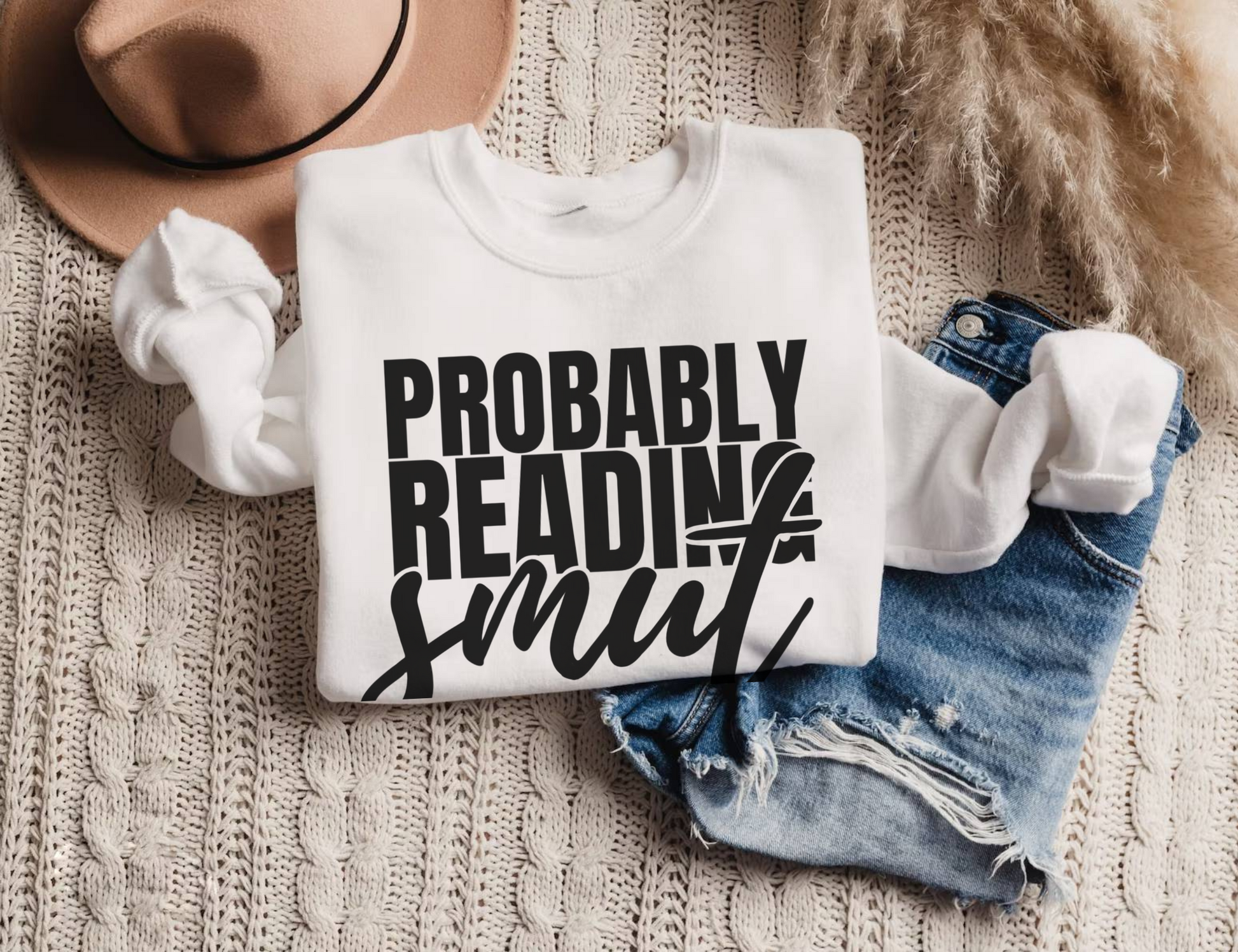 white Probably Reading Smut sweatshirt folded with knit texture and distressed denim shorts