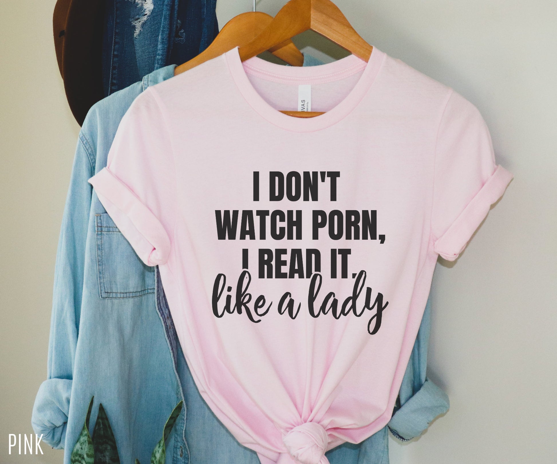 pink t-shirt that says i don't watch porn i read it like a lady styled with denim shirt on hanger