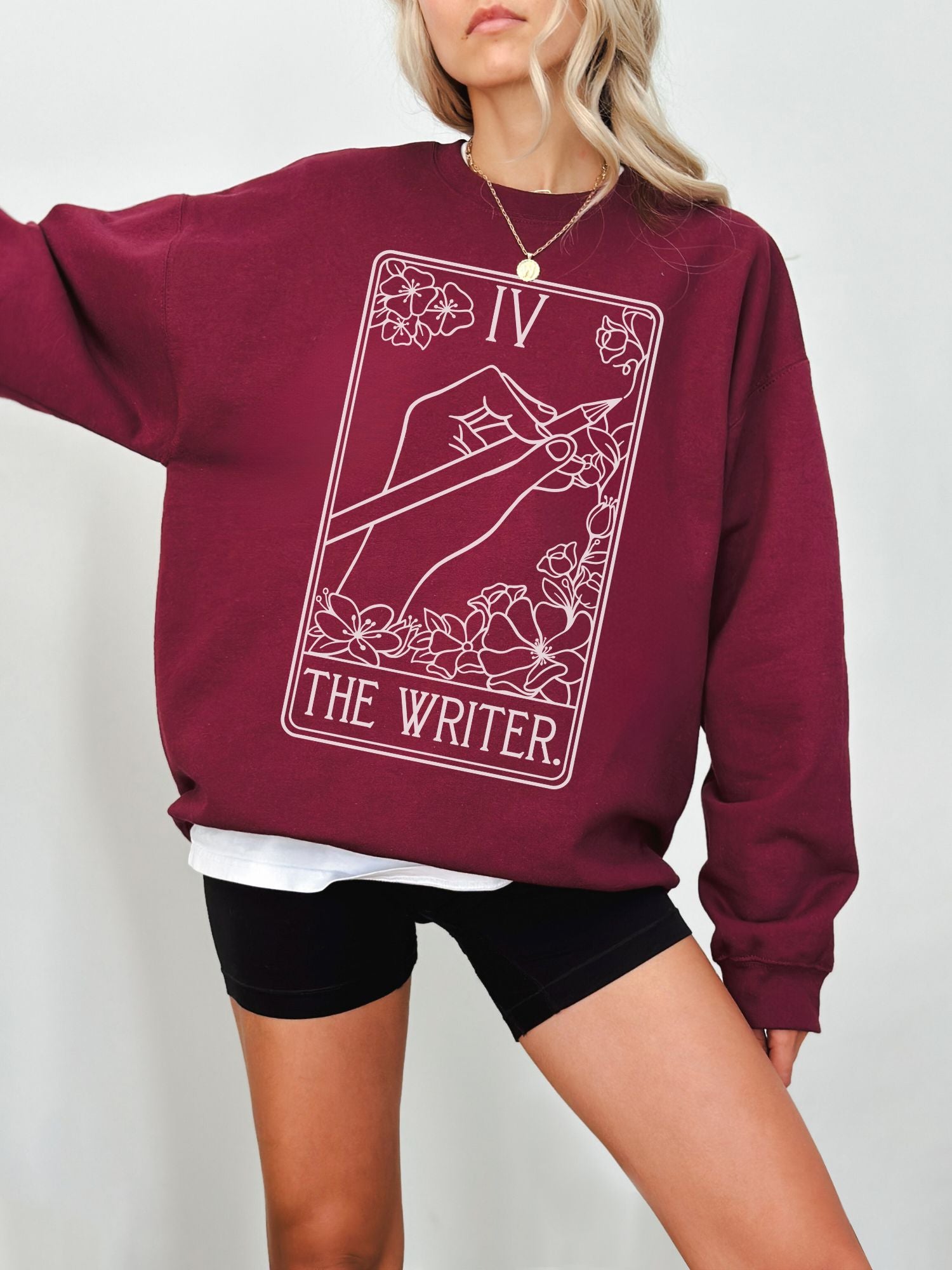 maroon author sweatshirt with floral tarot card artwork and lettering that says The Writer