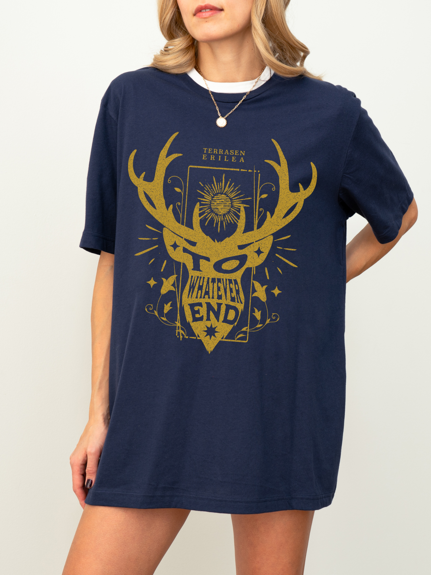 Close-up of a woman wearing a navy Terrasen shirt with gold fantasy design featuring antlers and stars