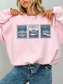 woman wearing oversized pink sweatshirt with Pride and Prejudice stamp illustrations of Longbourn House Pemberley House and Netherfield Park book lover aesthetic