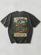Pepper t-shirt with graphic and text 'a book a day keeps the mental breakdown away' on a textured gray background