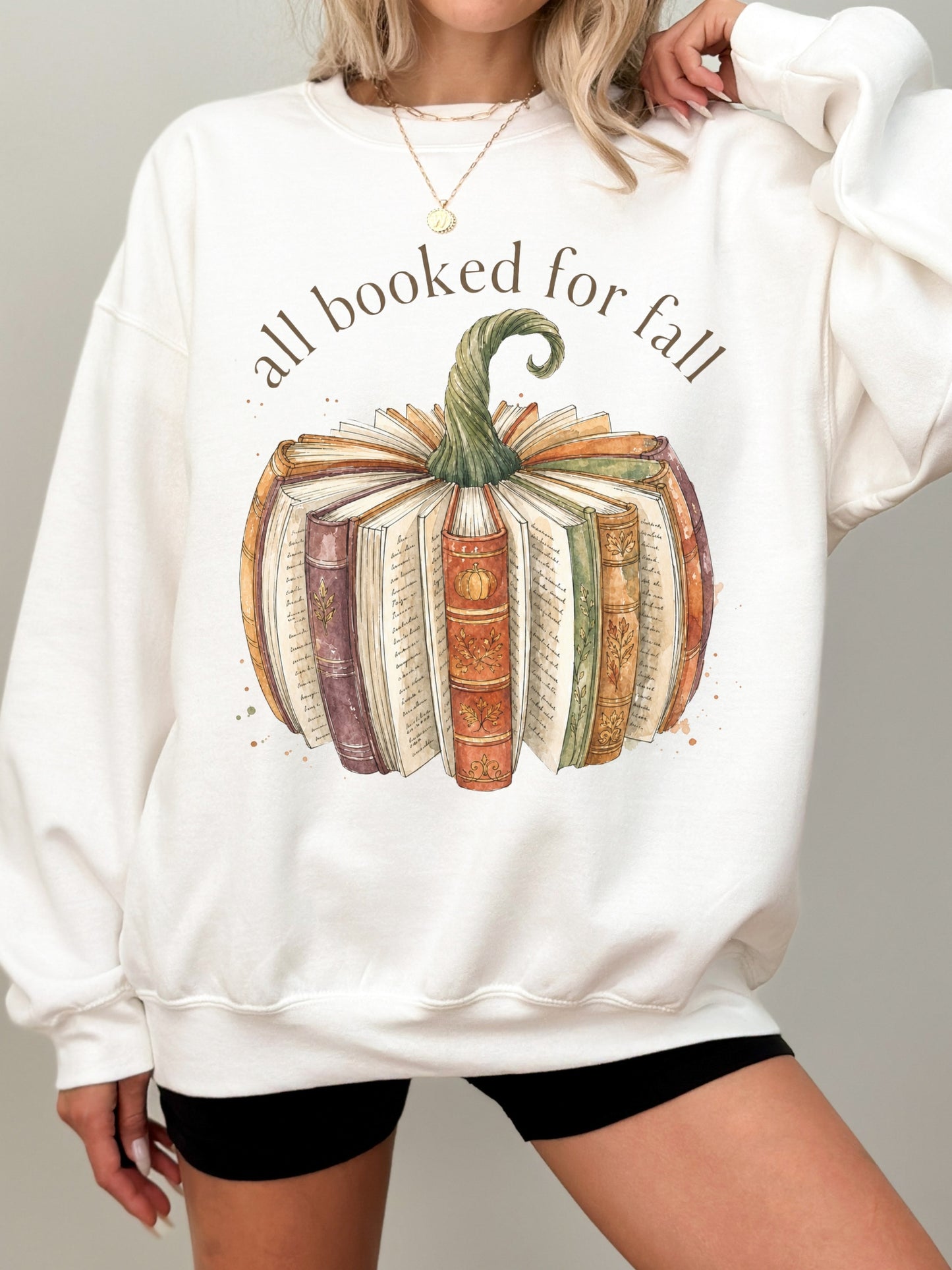 All Booked for Fall bookish pumpkin Gildan sweatshirt in white featuring vintage books and cozy autumn reading design