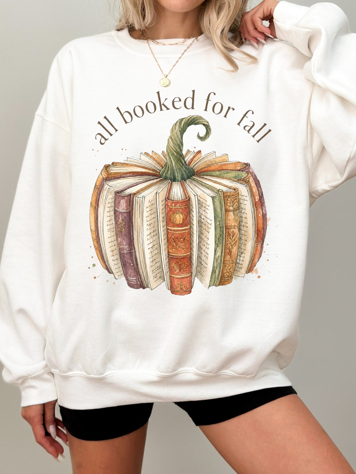 All Booked for Fall bookish pumpkin Gildan sweatshirt in white featuring vintage books and cozy autumn reading design