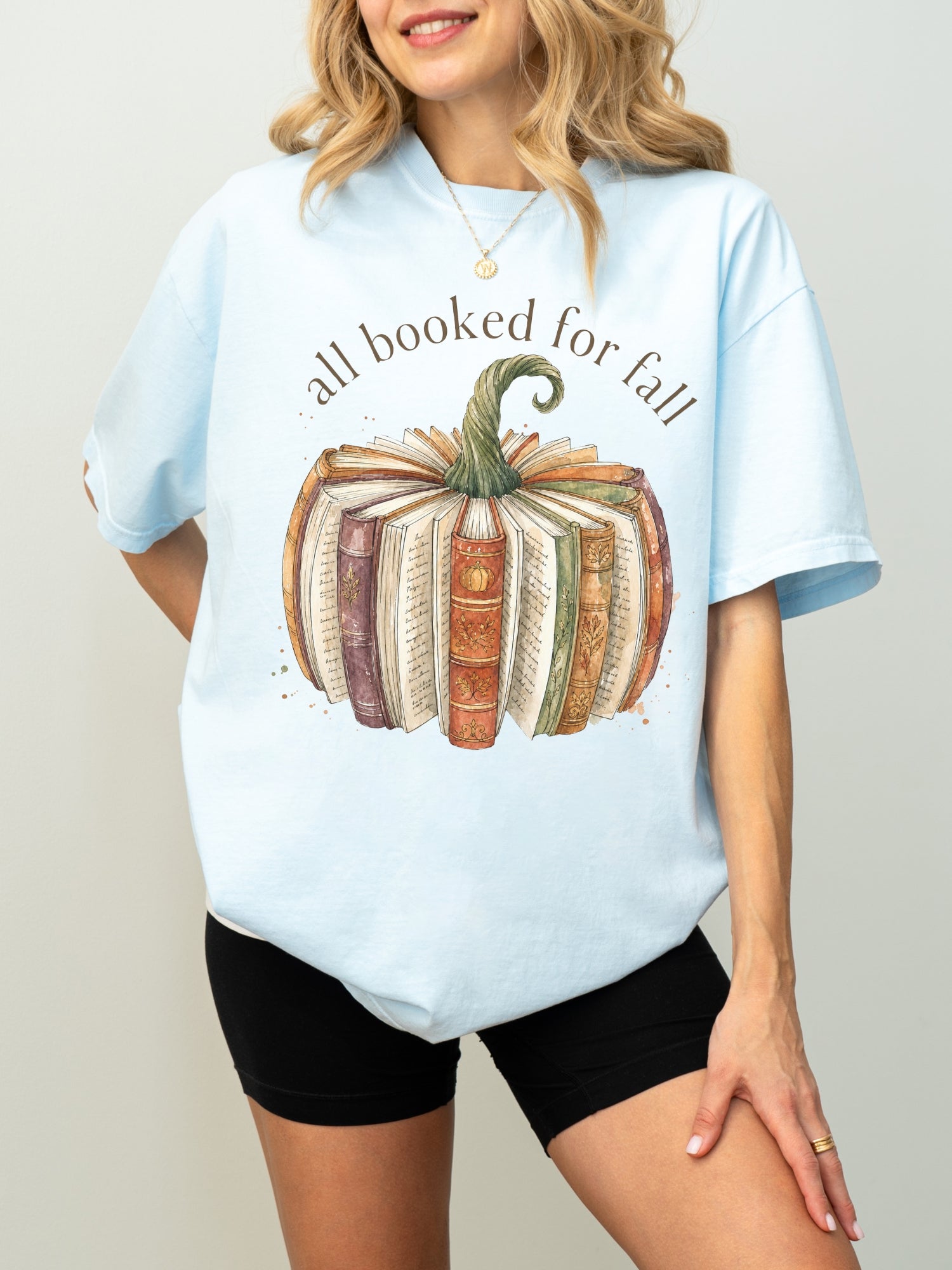 All Booked for Fall bookish pumpkin Comfort Colors shirt in chambray featuring vintage books and cozy fall reading design