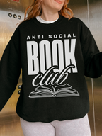woman wearing black sweatshirt with white anti social book club text standing inside elevator