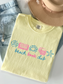 butter yellow comfort colors beach book club shirt flat lay with denim jeans hat necklace and colorful coastal reading graphic featuring seashell book crab books and starfish