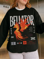 Black phoenix fantasy sweatshirt with Bellator type and healer quote. Worn by redhead model in an elevator with white striped pants and layered tee.

