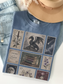 Flat lay of blue jean Comfort Colors fantasy book lover t shirt with vintage postage stamp collage featuring dragon sword moon books flowers castle and enemies to lovers artwork with jeans and hat