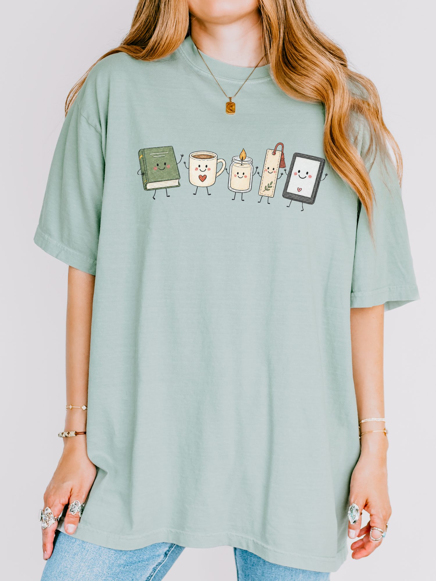 Comfort Colors book lover shirt featuring cute book, coffee, candle, bookmark and e-reader illustration in Bay