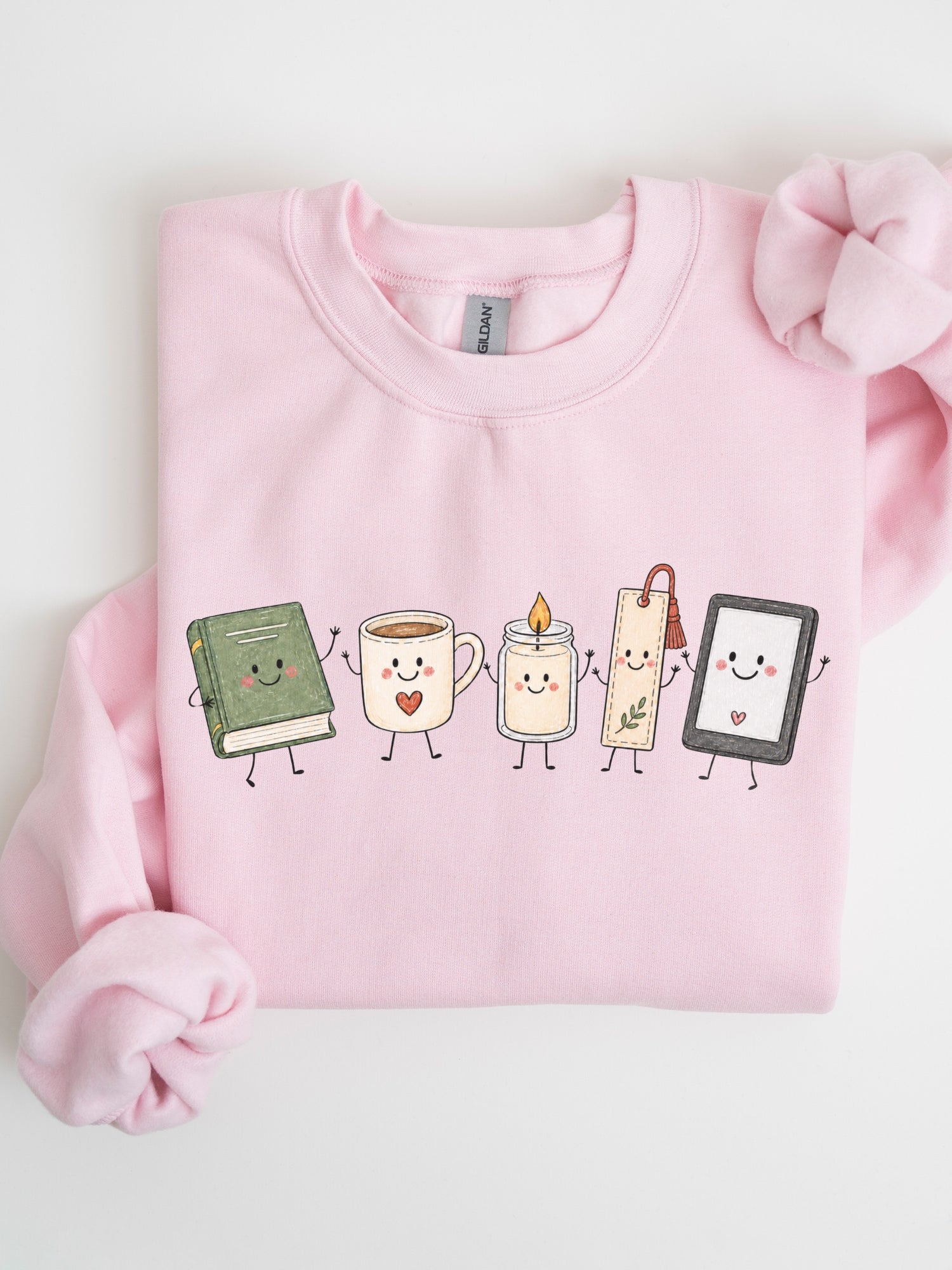 Gildan book lover sweatshirt featuring cute book, coffee, candle, bookmark and e-reader characters in Light Pink