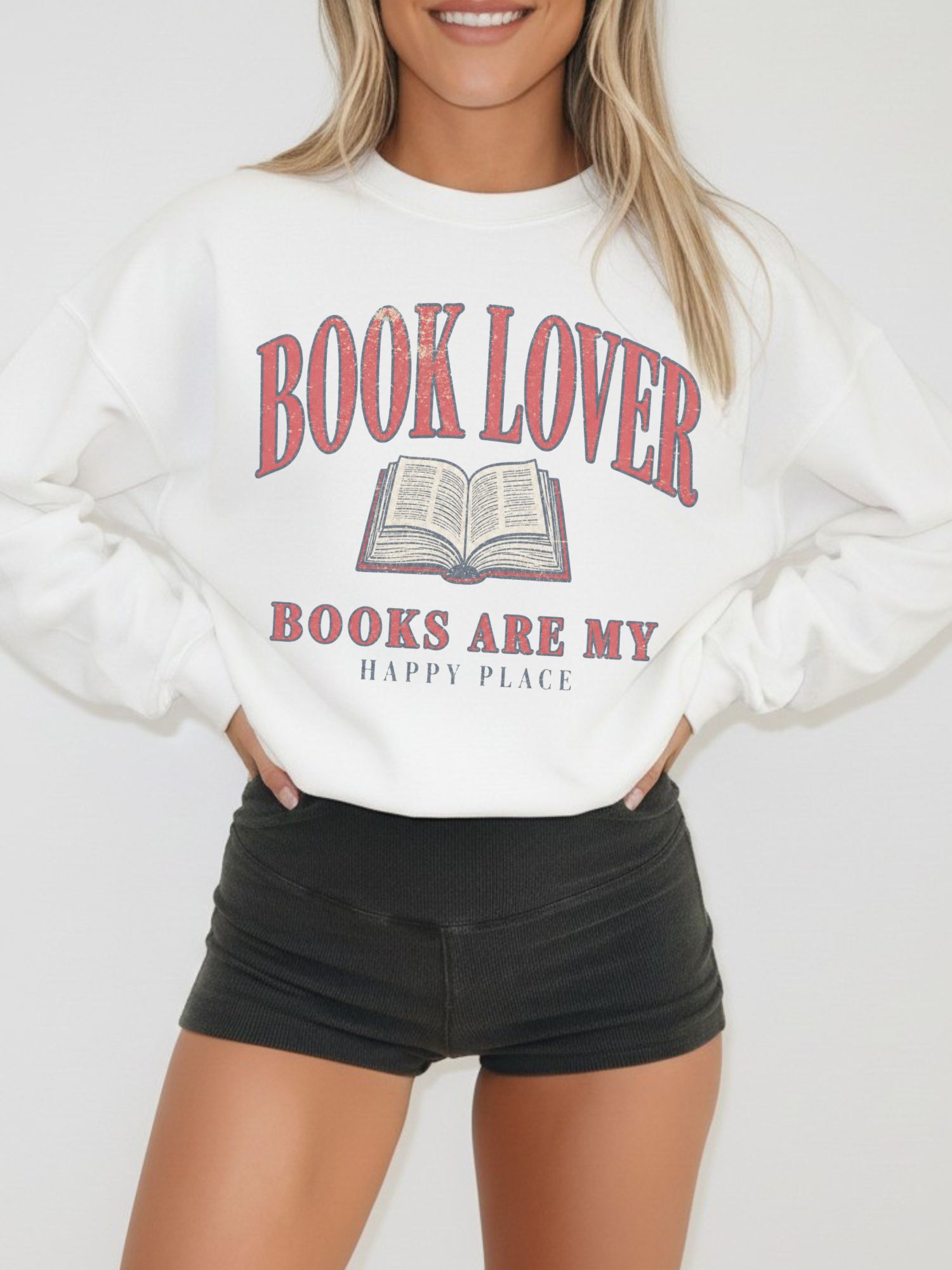 woman wearing a white book lover sweatshirt with vintage open book graphic and Books Are My Happy Place design