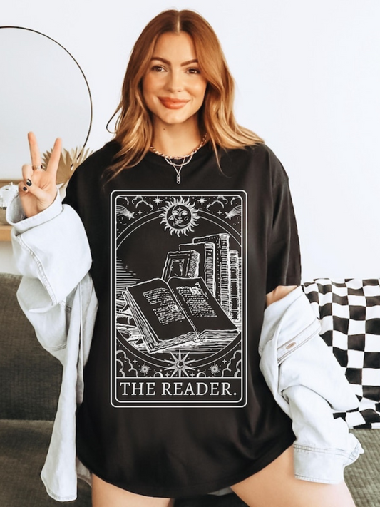 Woman modeling The Reader shirt in black with cozy cardigan, styled as casual book lover outfit
