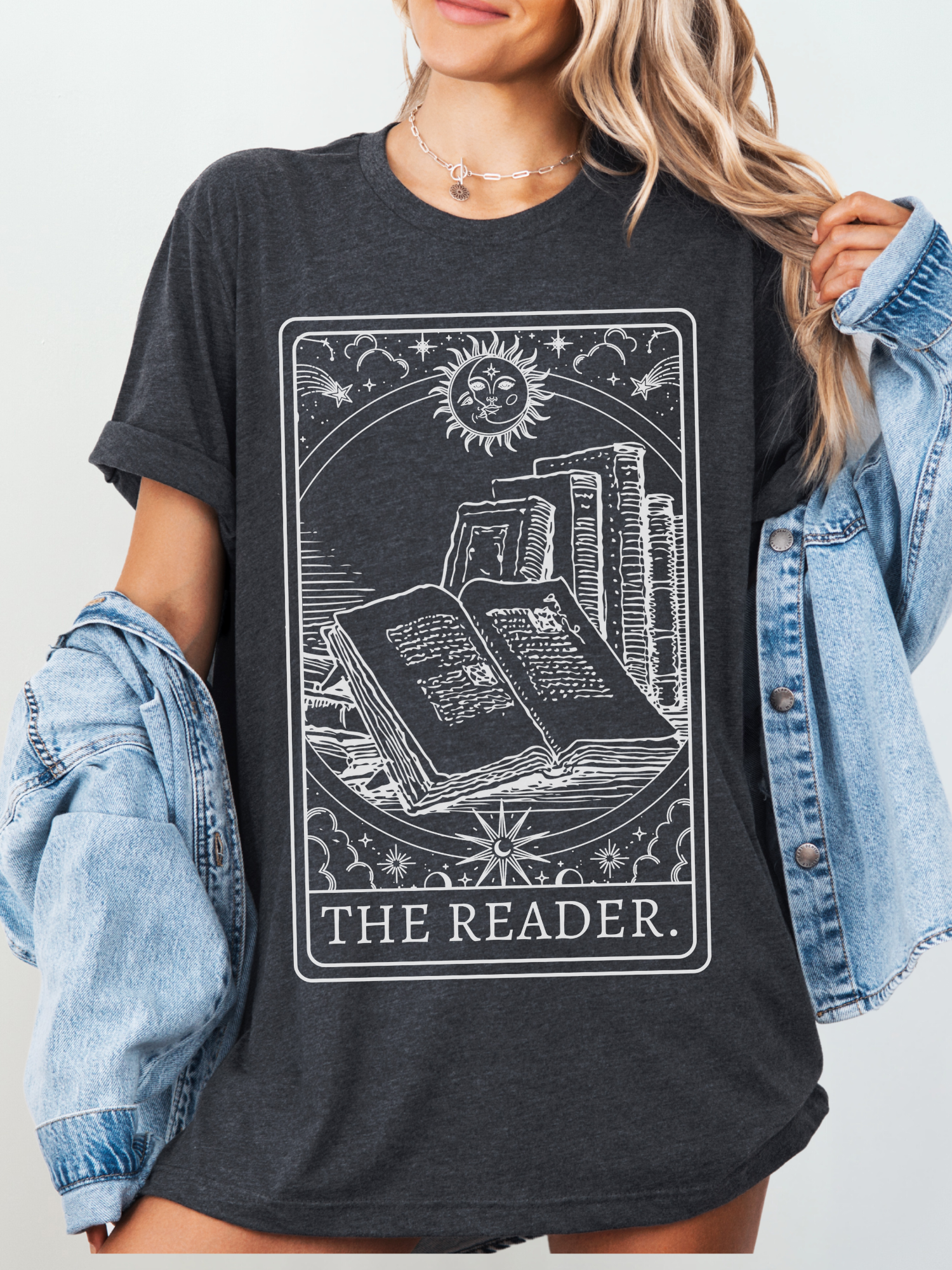Woman modeling The Reader shirt in dark grey with cozy jean cardigan, styled as casual book lover outfit