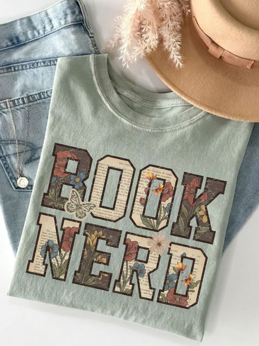 Bay Comfort Colors shirt featuring a vintage floral Book Nerd design with book page details, colorful wildflowers and butterflies, bookish t shirt for readers and book lovers