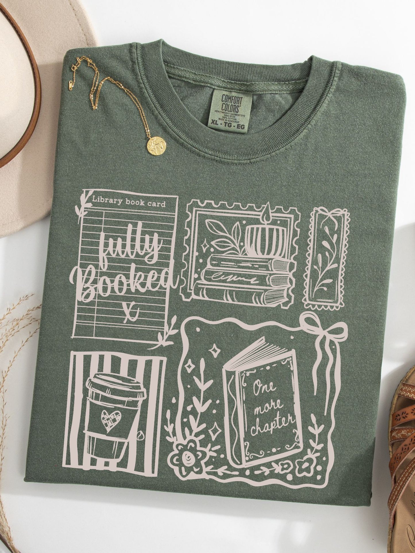 flat lay of a moss comfort colors shirt featuring 5 different book themed stamps