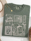 flat lay of a moss comfort colors shirt featuring 5 different book themed stamps