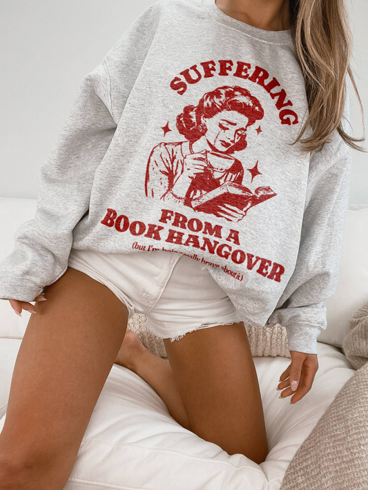 woman wearing ash grey sweatshirt with red text and retro book reader design about book hangovers