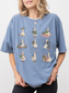 woman wearing blue jean comfort colors shirt with adorable reading geese illustration carrying books and cozy book lover artwork