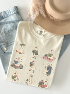 ivory comfort colors bookish goose reading shirt flat lay with cute duck reader illustrations books coffee mug jeans and beige hat styling