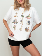woman wearing white comfort colors book lover goose shirt featuring cute reading ducks stacks of books coffee mugs and cozy reader design