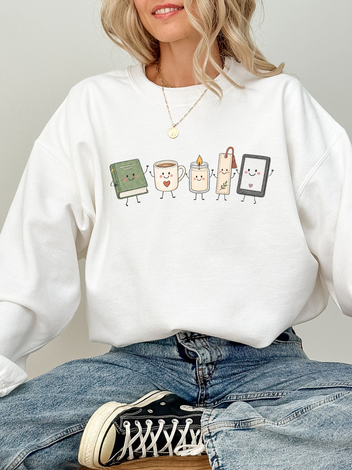 Gildan bookish reader sweatshirt featuring cute book, coffee, candle, bookmark and e-reader illustration in White