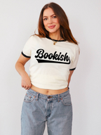 woman wearing ivory and black ringer t shirt with bookish graphic text paired with light wash jeans for casual reader aesthetic