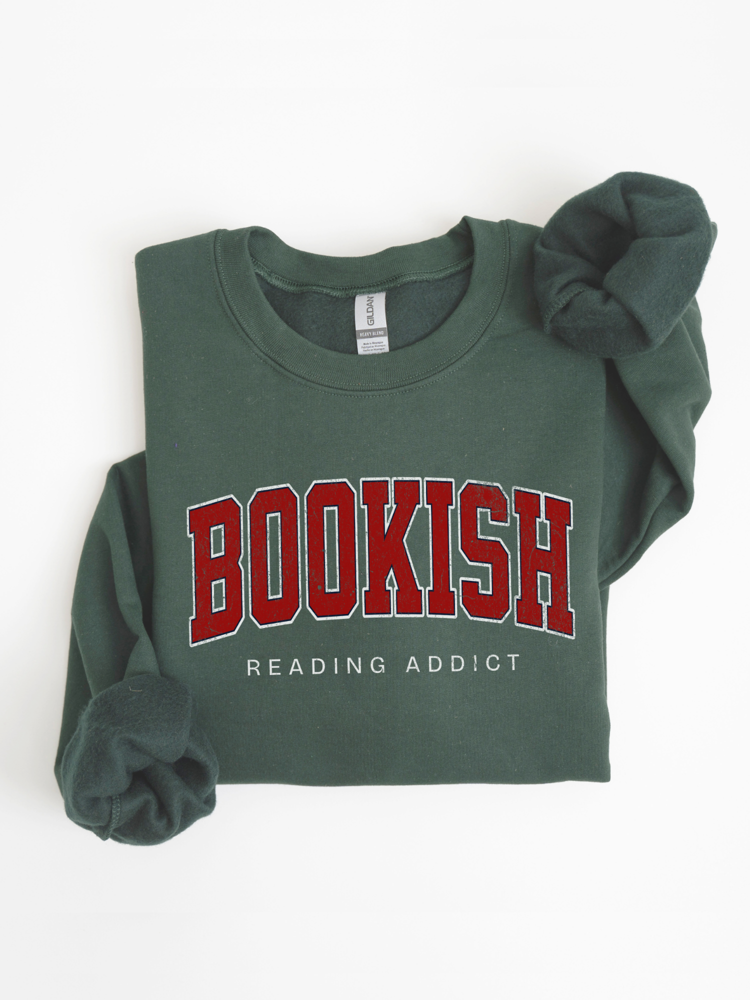 folded forest green sweatshirt with red varsity "Bookish" text and “Reading Addict” on front