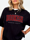 woman wearing black Comfort Colors shirt that says Bookish Reading Addict in red varsity lettering
