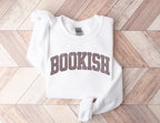 folded white sweatshirt with brown varsity-style bookish text on light wood herringbone background