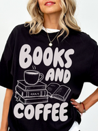woman wearing a black Comfort Colors shirt featuring a books and coffee graphic with stacked books, open book, and steaming coffee cup illustration, oversized bookworm shirt perfect for readers librarians and coffee lovers