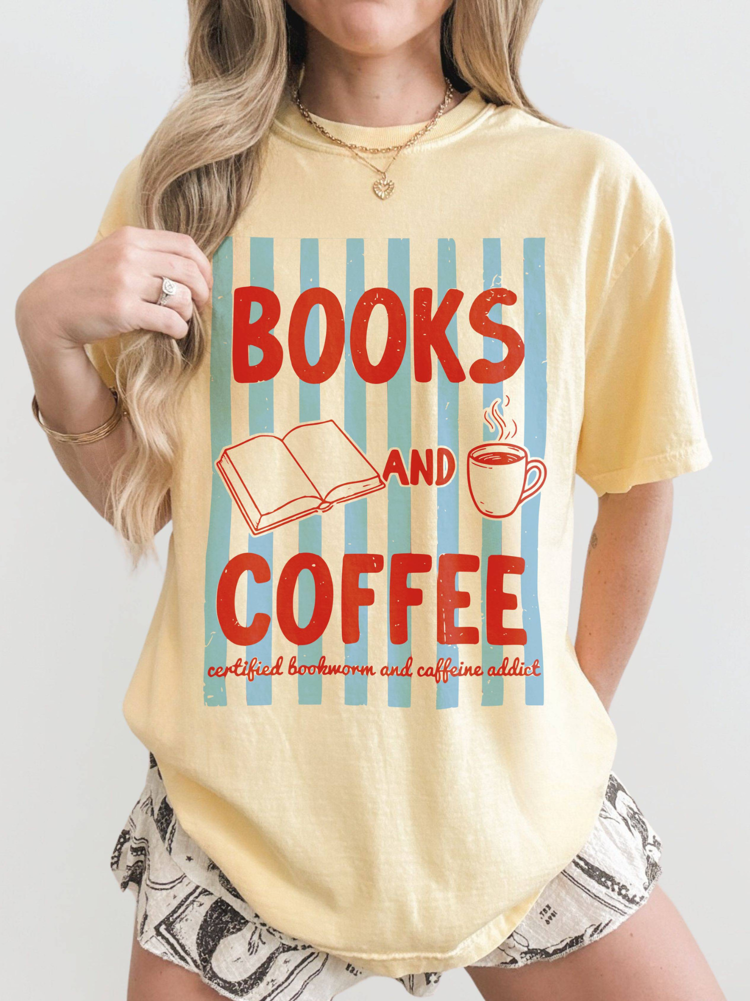 woman wearing butter books and coffee graphic t shirt with retro striped background open book illustration and coffee mug for bookworm aesthetic