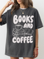 woman wearing a pepper Comfort Colors shirt featuring a books and coffee design with illustrated stacked books, open book, and coffee cup, cozy oversized bookworm shirt for readers and librarians