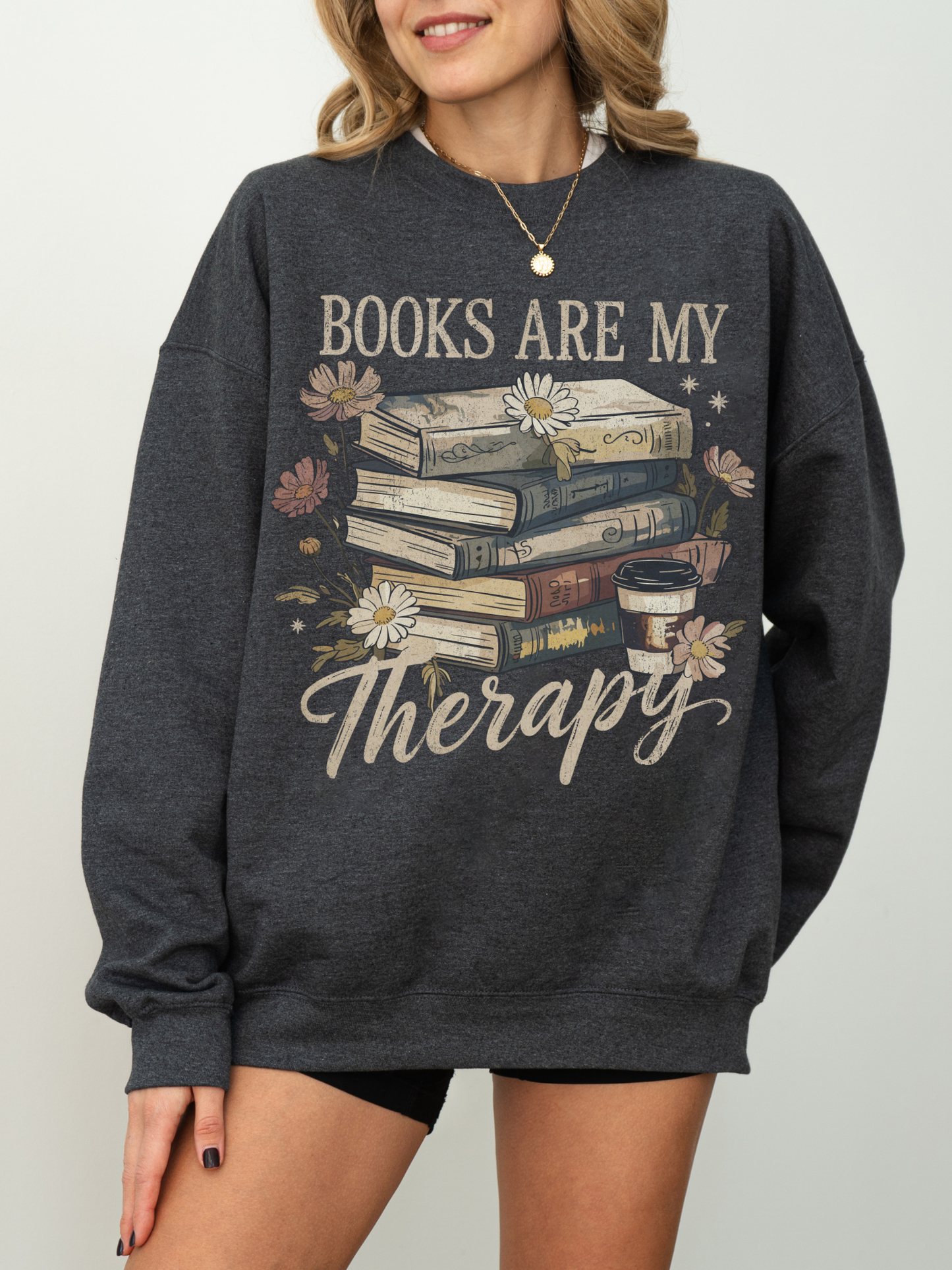woman modeling dark heather gray sweatshirt with retro flower and book design and quote books are my therapy
